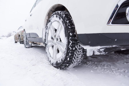 cars with winter tires are on the snow-covered ground