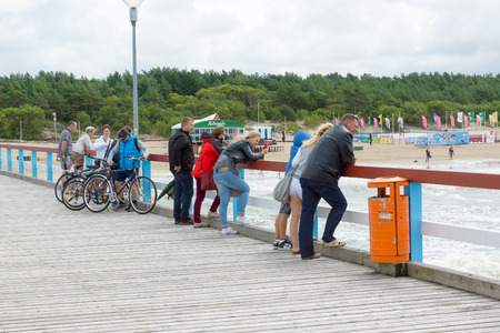 PALANGA, LITHUANIA - AUGUST 08,2015: Marine pier with a strolling tourists in the city of Palanga.Palanga is one of the main tourist towns in Lithuania.のeditorial素材