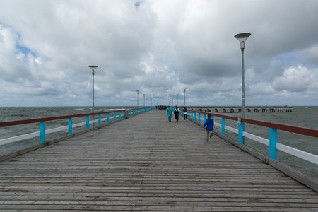 PALANGA, LITHUANIA - AUGUST 08,2015: Marine pier with a strolling tourists in the city of Palanga. Palanga is one of the main tourist towns in Lithuania.のeditorial素材