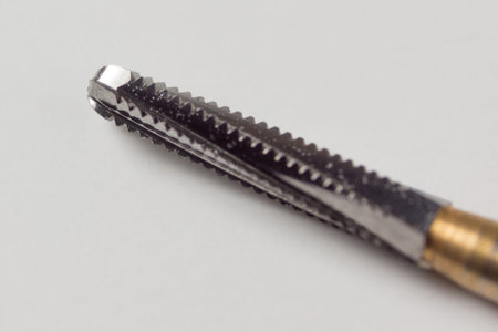 dental turbine handpiece with burs on a white background