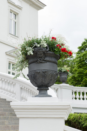 big flowerpot with flowers for decoration of an architectural constructionの写真素材