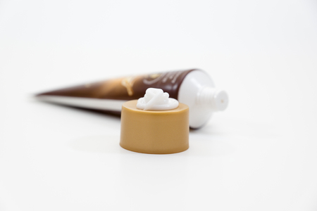 tube with a small amount of the squeezed out white creamの写真素材