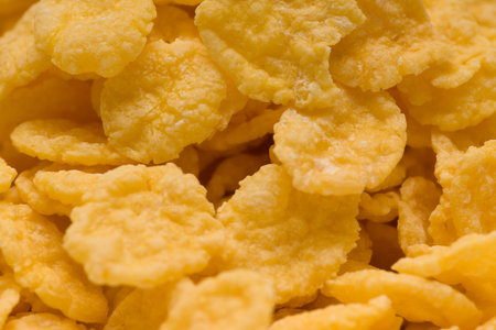 yellow cornflakes photographed close-up on the plate