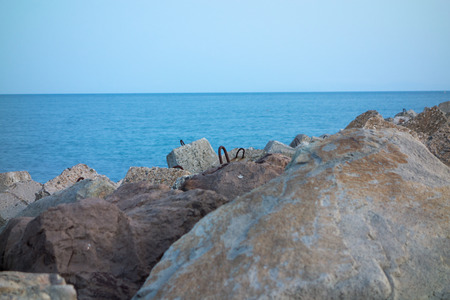 huge chunks of concrete with reinforcement to protect the shore from the surfの写真素材