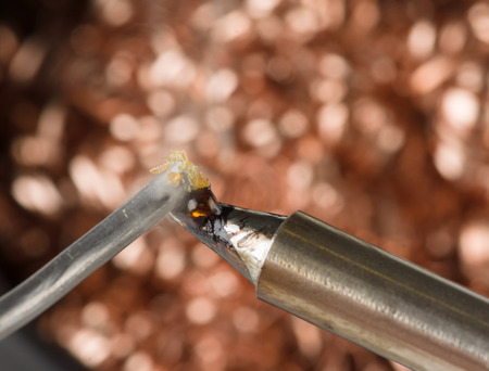 Metal chips in the tank is used to clean the soldering iron from the depositの写真素材