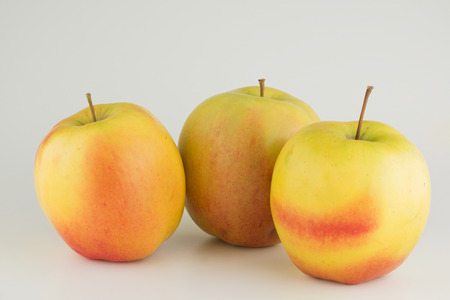 Three large ripe apples on a white backgroundの写真素材