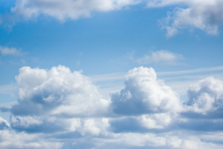 White cumulus clouds are on a blue skyの写真素材