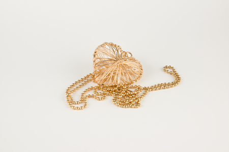 Decoration in the form of a heart made of wire isolated on white backgroundの写真素材