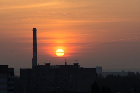 huge yellow sun rises over the cityの写真素材