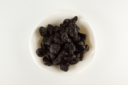 hill of prune in a plate isolated on a white backgroundの写真素材
