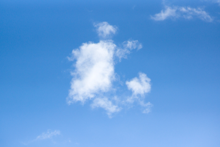 White cumulus clouds are on a blue skyの写真素材