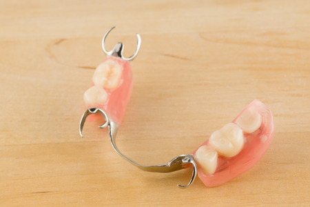 arc dental prosthesis lies on a wooden backgroundの写真素材