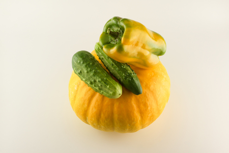 huge yellow pumpkin with pepper and cucumber isolated on white backgroundの写真素材