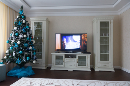 Christmas tree decorated with toys in the home interiorの写真素材