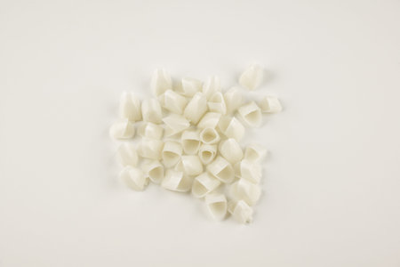 variety of artificial temporary dental crowns isolated on white background