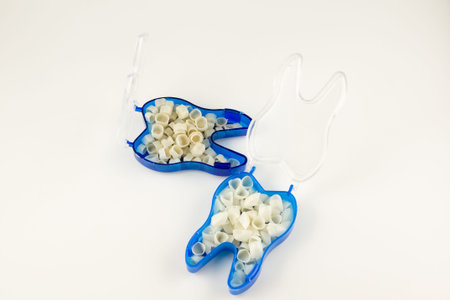 variety of artificial temporary dental crowns isolated on white background