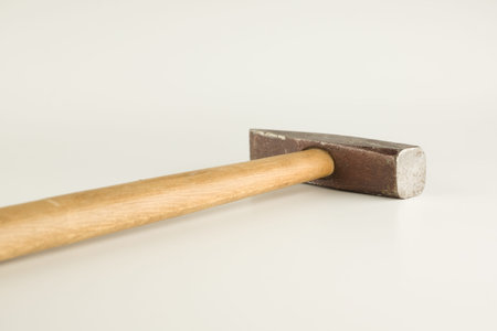 Small hammer with wooden handle isolated on a white background