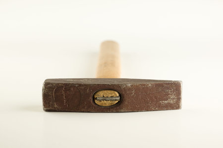 Small hammer with wooden handle isolated on a white background