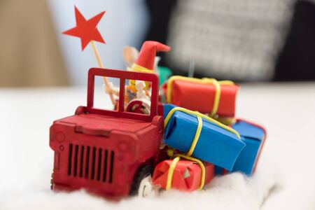 small Christmas toy homemade in the form of a car with giftsの写真素材