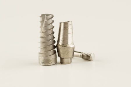 Dental titanium implant with locking elements isolated on whiteの写真素材