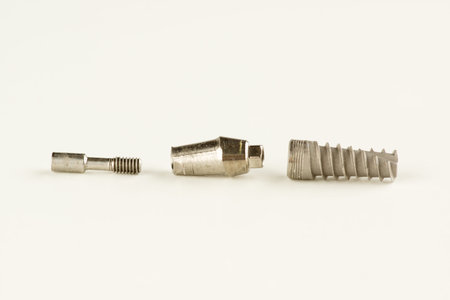 Dental titanium implant with locking elements isolated on white