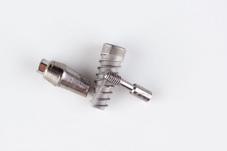 dental titanium implant with locking elements isolated on white background