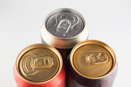 three metal cold cans with beer on a white background
