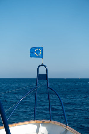 the bow of a ship with a developing EU flag