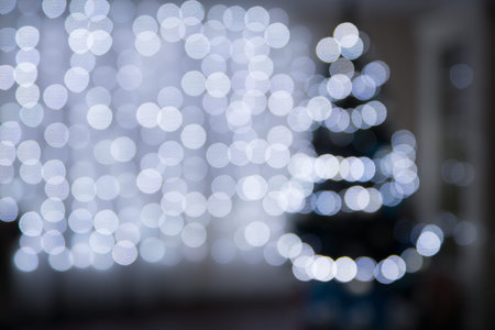 defocused image of christmas lights on a light backgroundの写真素材