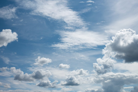 Blue sky with white light clouds in the foreground