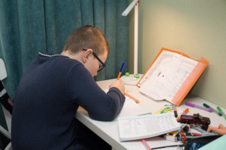 student doing homework sitting at desk at home
