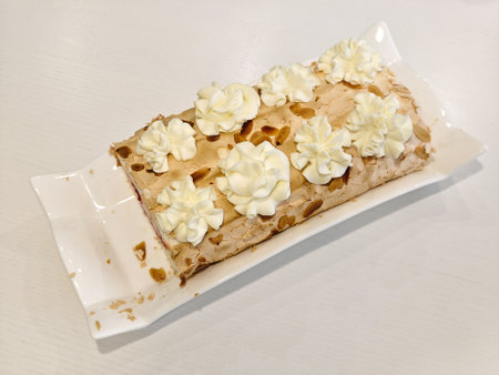 delicious sweet meringue roll on a plate with jamの写真素材