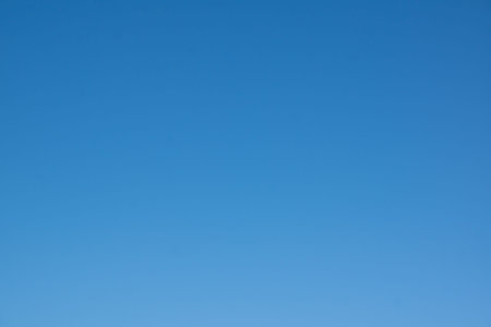 Blue sky with white light clouds in the foregroundの写真素材