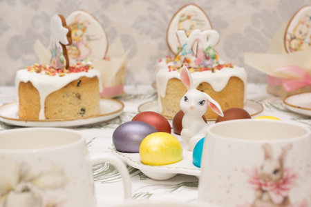 Traditional Easter dinner or brunch with ham, colored eggs, hot cross buns, cake and vegetables....