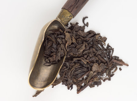 Stylish vintage bronze tea ceremony spoon on white background