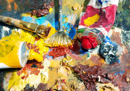 Palette of the artist with tubes of paint and brushes. Closeup.の写真素材