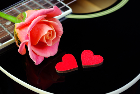 Hearts of lovers, beautiful rose and black guitar guitar. Valentine's Day.の写真素材