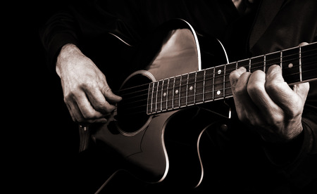 Playing an Acoustic Guitar. Guitarist hands and guitar close up.の写真素材