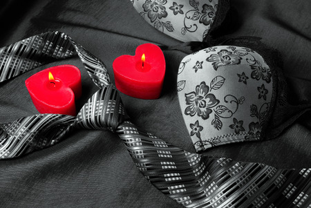 Close-up photo of gray men's tie and women's bra. Prelude of love. Romantic evening.の写真素材