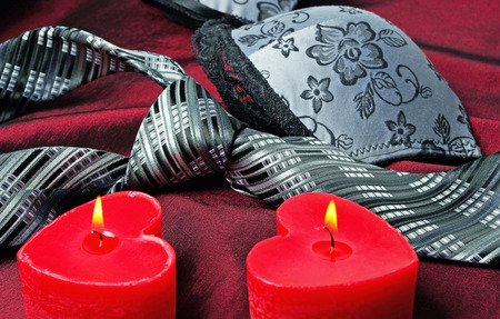 Close-up photo of gray men's tie and women's bra. Prelude of love. Romantic evening.の写真素材