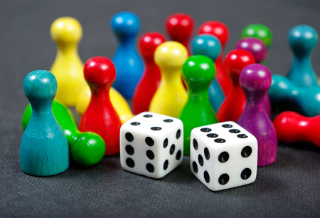 Colorful play figures with dice on board. Close up.の写真素材