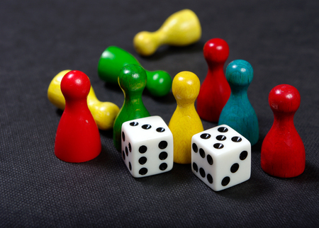 Colorful play figures with dice on board. Close up.の写真素材