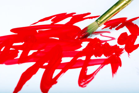 Artist brush and red brushstrokes on whiteの写真素材