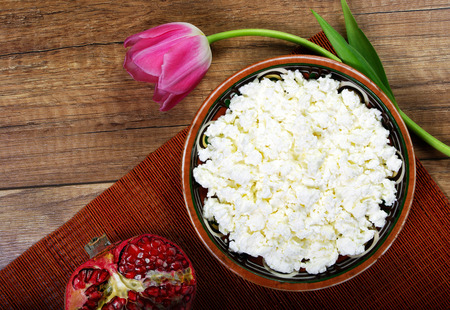 Homemade cottage cheese in a bowl and tulips.の写真素材
