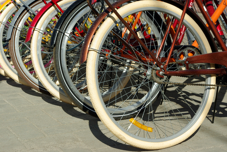 Various bicycles on a rack, available for rentの写真素材