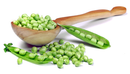 green peas in a wooden spoon. vitamins B. concept of a healthy diet.の写真素材
