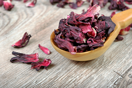 Hibiscus tea. Hibiscus tea in a wooden spoon. Vitamin tea for cold and flu.の写真素材