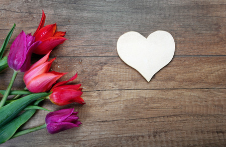 heart symbol of love and tulips on a wooden background. St. Valentine's Day. Mothers Day. copy spaces.の写真素材