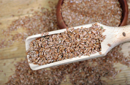 linsed flax seeds in wooden scoop
