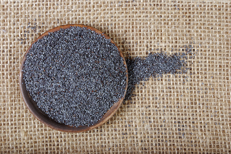 dry poppy seeds in a bowl. top viewの写真素材